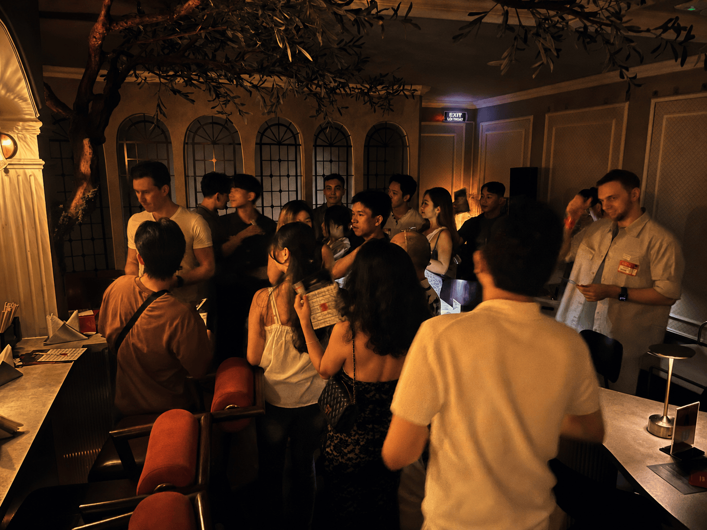 Guests mingling at OMG Matchmaking’s Hello Saigon speed dating event in a romantic lounge setting